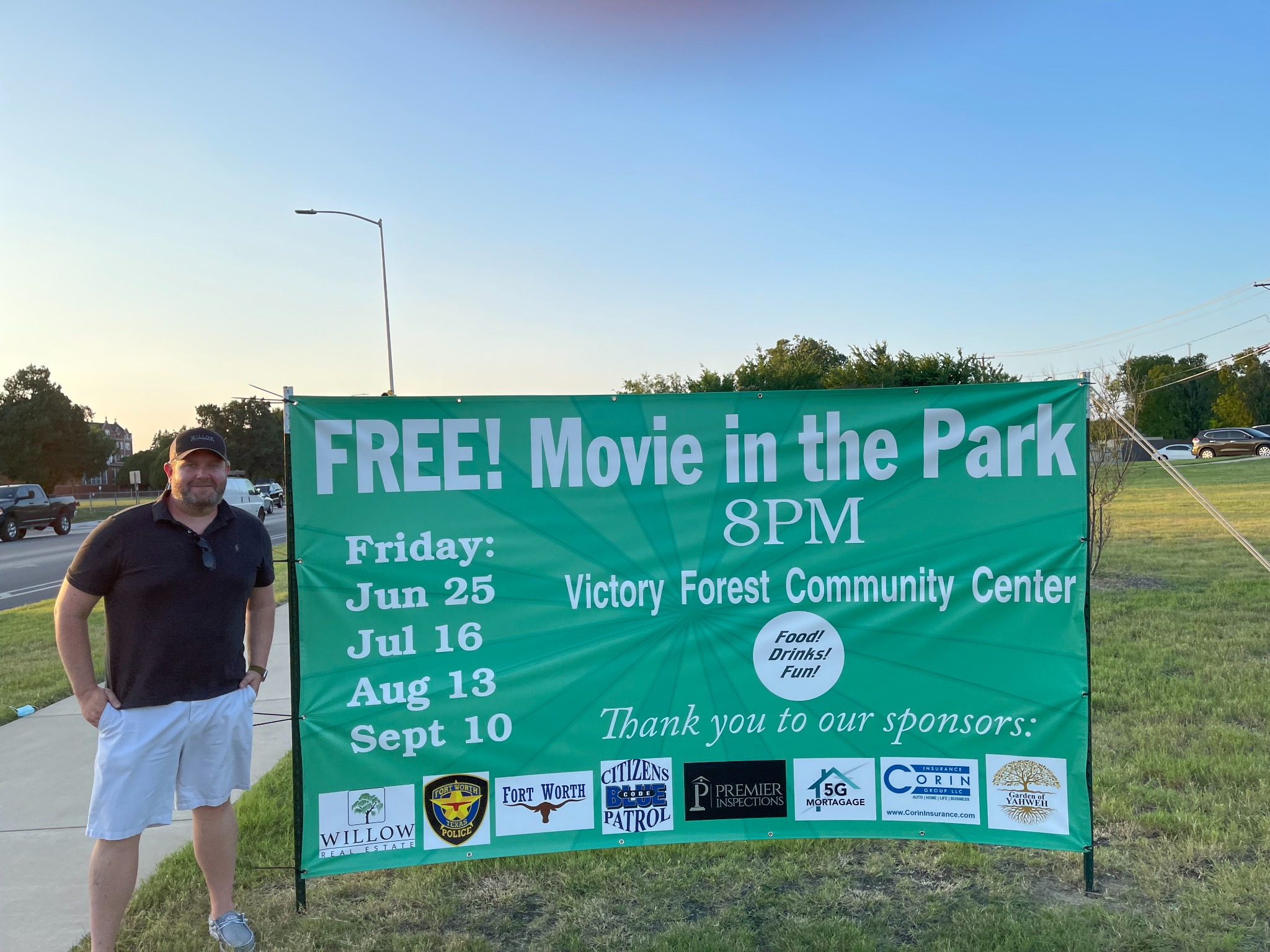 Todd Bingham beside a community movie-night sponsorship sign that includes the Willow logo